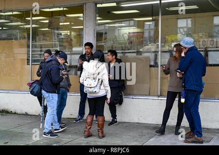 Young people all using cellphones Stock Photo