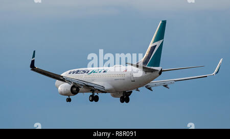 WestJet Airlines plane Boeing 737 jet airliner airplane final approach landing Stock Photo