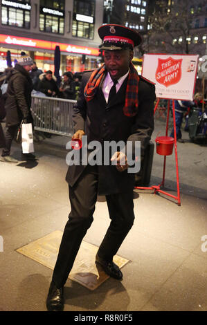 Salvation Army soldier performs for collections in midtown Manhattan Stock Photo