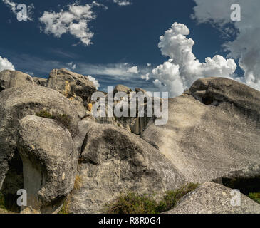 Giant limestone boulders and dramatic cloudy sky in Castle Hill, South Island New Zealand Stock Photo