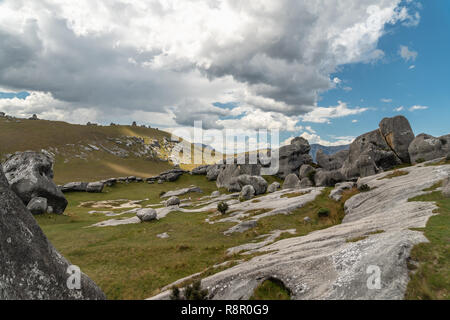 Giant limestone boulders and dramatic cloudy sky in Castle Hill, South Island New Zealand Stock Photo