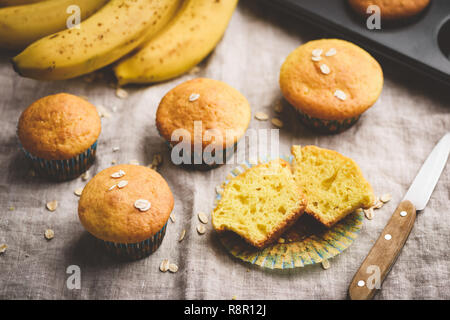 Healthy oat banana muffins on table. Muffin cut in halves Stock Photo
