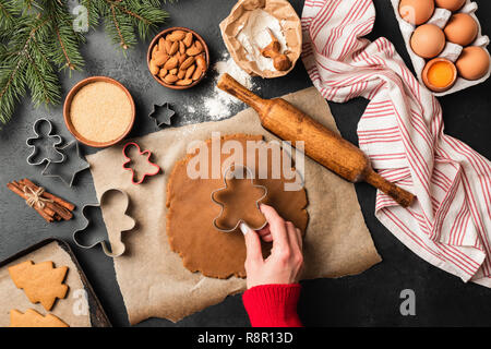 Preparation of gingerbread man cookies. Holiday baking concept. Top view Stock Photo
