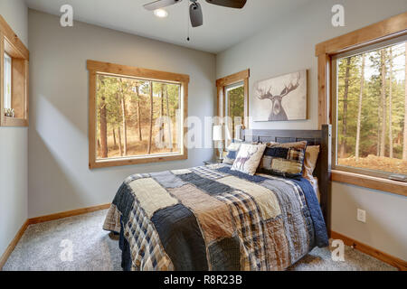Country style bedroom with wooden bed and beautiful view of the back yard. Stock Photo
