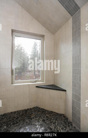 Renovated white subway tile bathroom shower with glass door Stock Photo ...