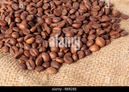 Beans of coffee scattered on a sacking Stock Photo