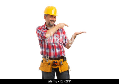 Builder with trustworthy expression presenting blank copyspace in palm isolated on white studio background Stock Photo