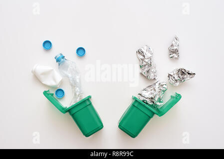 Foil and plastic. Crumple foil and plastic falling to the recycling bin Stock Photo