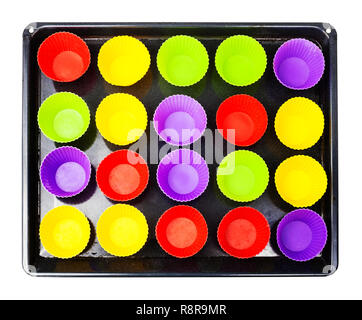 top view of tray with many empty multicolor silicone molds for cupcakes isolated on white background Stock Photo