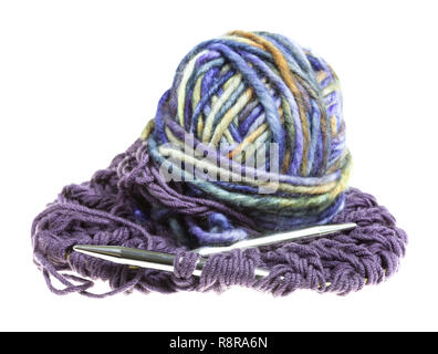 ball of multi-colored yarn and knitting needles in knitted cloth isolated on white background Stock Photo