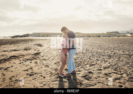 Love and romance concept for young millennial couple enjoying the sunny day at the beach - attractive people in summer vacation or outdoor romantic le Stock Photo