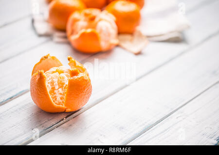 Fresh pieces of tangerines mandarin on wooden table. Stock Photo