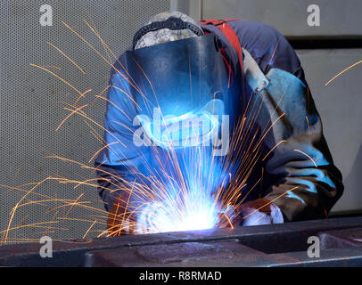 welder works in an industrial company - production of steel components Stock Photo