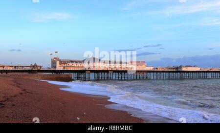 BRIGHTON, EAST SUSSEX, ENGLAND, UNITED KINGDOM - NOVEMBER 13, 2018: Landscape panorama of Brighton Palace Pier and Brighton Beach at dusk. Stock Photo