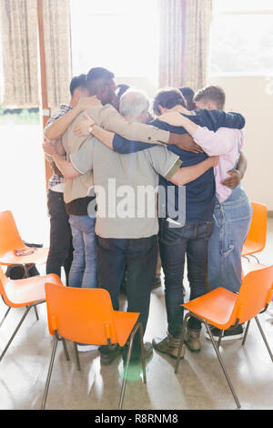 Group of people in huddle Stock Photo - Alamy