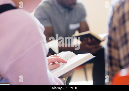 Close up men reading bible in prayer group Stock Photo