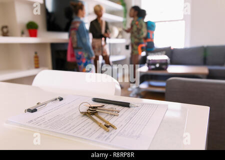 House keys and contract on table in house rental Stock Photo