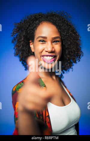 Portrait confident young woman gesturing thumbs-up Stock Photo