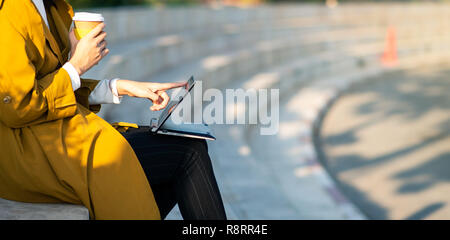 Woman using computer outside of the office in the park Stock Photo