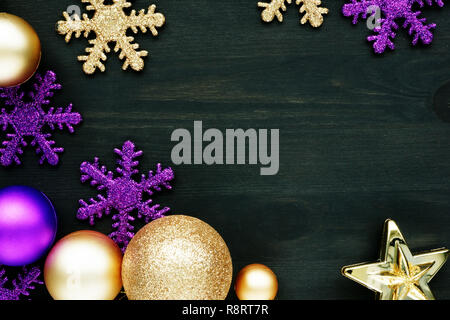 Christmas decoration balls and snowflakes on a dark wooden background with free space. Stock Photo