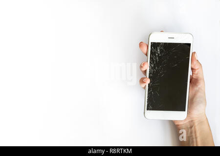 Smartphone with broken screen in hand on white background Stock Photo