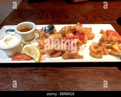 Deep fried seafood on plate with sauce Stock Photo