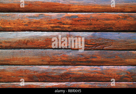 Dark brown wood log wall of an aging log cabin for texture, background or banner Stock Photo
