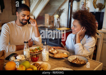 holidays and celebration concept - happy African couple having Christmas dinner at home Stock Photo