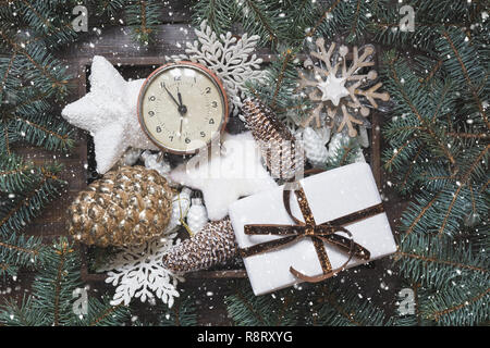 Crate full of Christmas white wooden ornaments for decor on wooden board. View from above. Holiday card. Xmas. Stock Photo