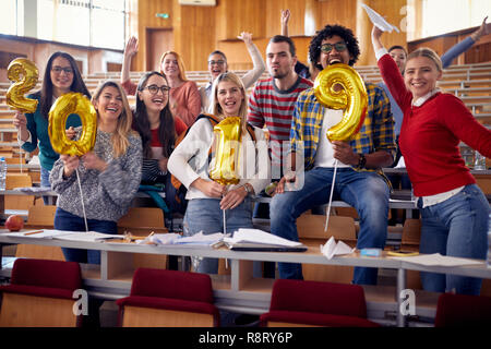 Smiling students having party on university celebrating holiday Stock Photo