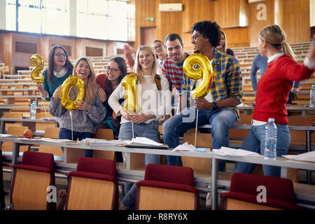 Happy friends having party on university celebrating holiday Stock Photo