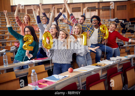 Smiling friends having party on university celebrating holiday Stock Photo