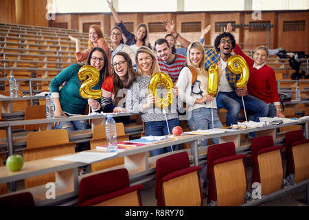 Smiling young friends having party on university celebrating holiday Stock Photo