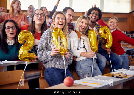 Group of colleagues having fun at new year celebration on university Stock Photo