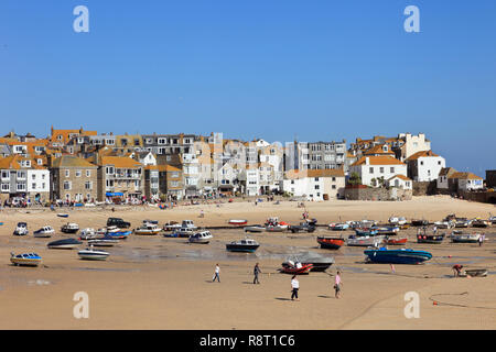 View of moored boats in the sandy harbour at low tide. St Ives, Cornwall, England, UK, Great Britain Stock Photo