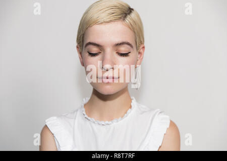 Serene young woman with eyes closed Stock Photo