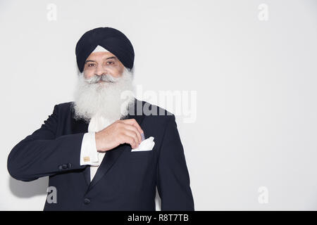Portrait confident senior man with white beard wearing turban Stock Photo