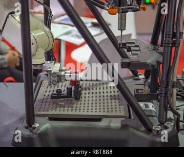 CMM Coordinate Measuring Machine work with robotic arm loading wokpiece Stock Photo