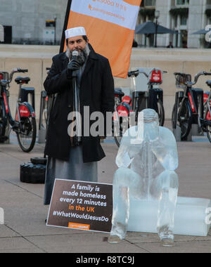 London UK 17 December 2018 Ibrahim Mogra is an imam from Leicester and Assistant Secretary General of the Muslim Council of Britain in Canary Wharf station, in the heart of the financial district, international humanitarian charity, Penny Appeal  unveiled 5 life-size ice statues symbolizing homeless families to promote their winter campaign. The frozen family will depict the plight of the 140* families who become homeless every day, and the 900* children who become homeless every month, right here in the UK.@Paul Quezada-Neiman/Alamy Live News Stock Photo