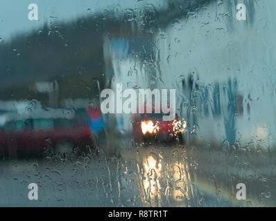Lyme Regis, Dorset, UK. 18th December 2018.  UK Weather: A Wet and windy day at Lyme Regis. The Royal Mail delivery in pouring rain at Lyme Regis this morning.  A yellow warning of rain is place across the South West.  Credit: PQ Images/Alamy Live News Stock Photo