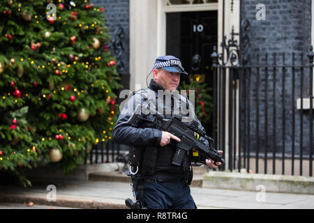 London, UK. 18th December, 2018. An armed police officer passes in front of 10 Downing Street during the final Cabinet meeting before the Christmas recess. Credit: Mark Kerrison/Alamy Live News Stock Photo