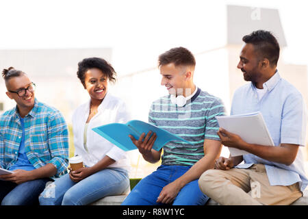 international students with notebooks outdoors Stock Photo