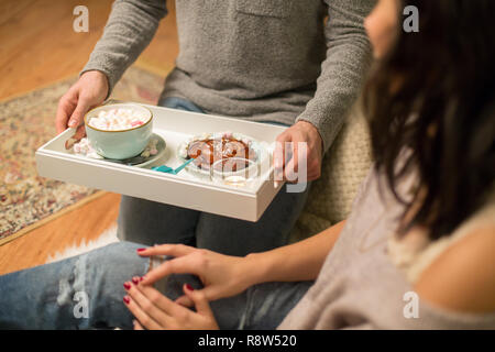 close up of couple with hot chocolate at home Stock Photo