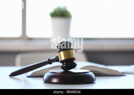 The judge hammer lies on table in Stock Photo