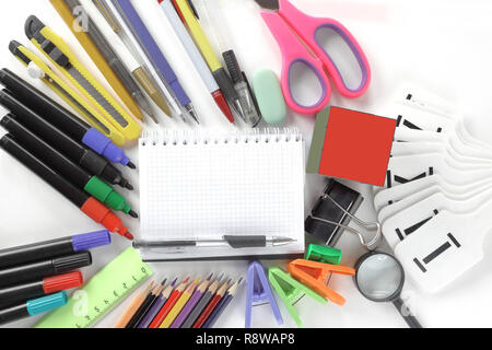 opened Notepad and office supplies on white background.photo with copy space Stock Photo