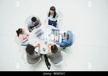 High angle view businesswoman leading meeting at round table Stock Photo