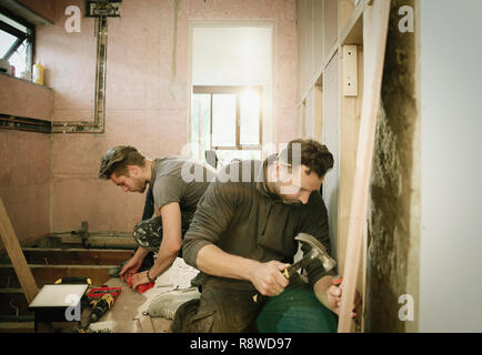 Construction workers working in house Stock Photo