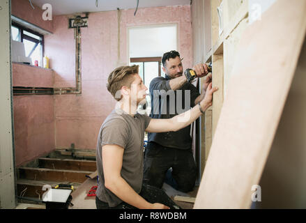 Construction workers framing inside of house Stock Photo