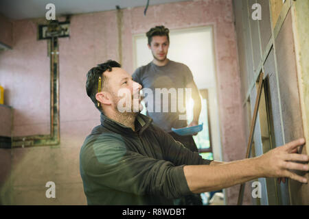 Construction workers framing inside of house Stock Photo