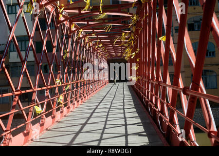 Pedestrian on bridge over Onyar river in Gerona Spain Stock Photo